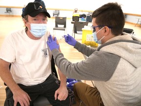 Tillsonburg's Sean Orpen, left, receives a dose of COVID-19 vaccine from Juan Gomez during a pop-up clinic at the Straffordville Community Centre on Thursday, Jan. 14. (Chris Abbott/Norfolk and Tillsonburg News)