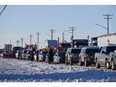Truckers protesting a COVID-19 vaccine mandate for those crossing the Canada-U.S. border cheer are seen on the Trans-Canada Highway west of Winnipeg earlier this week.