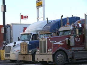 Transport trucks parked at the Roadking Travel Centre in Calgary as vaccine mandates at the U.S. border could worsen supply chains on Tuesday, January 11, 2022.