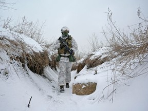 A member of the Ukrainian armed forces takes up a combat position near the line of separation from Russian-backed rebels outside the town of Avdiivka in Donetsk Region on Jan. 25. But the threats aren't just physical: cyber attacks can do real damage. REUTERS/Maksim Levin