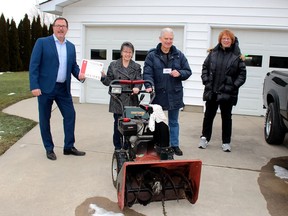 Mayor Darrin Canniff, left, presents a certificate to Zedina and Bob Muxlow, of Wallaceburg, for their good deeds through the Chatham-Kent Good Neighbour Recognition Program. The Muxlows were nominated by Cheryl Knight, right, who also suggested the program to the municipality. Ellwood Shreve/Postmedia