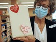 Until Valentine's Day, the Port Stanley and Shedden branches of the Elgin County Library are offering blind dates with books. Port library assistant Paula Miziolek holds one of the paper-wrapped offerings. (Eric Bunnell photo)
