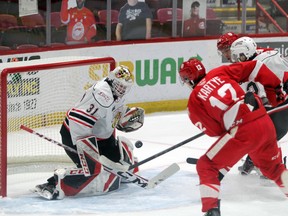 Nick Chenard tracks the puck in the first period with Greyhounds Tye Kartye and Cole MacKay lurking in front and defender Taos Jordan working to clear as the Owen Sound Attack take on Sault Ste. Marie inside the GFL Memorial Gardens Saturday, Jan. 15, 2022. Gordon Anderson/Sault Star