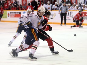 Artur Cholach (91) and Gavin Bryant battle for the puck in the Colts zone as the Owen Sound Attack host Barrie inside the Harry Lumley Bayshore Community Centre Sunday, Jan. 9, 2022. Greg Cowan/The Sun Times