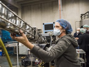 A worker at Sprague Foods Ltd oversees cans as they travel on their way to be labeled. Tuesday inside the Sprague Foods facility in Belleville, Ontario. ALEX FILIPE