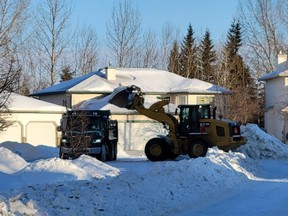 City crews work to clear snow and ice on a Windrose street, one of three Leduc neighbourhoods where snow removal was not completed, as of February 1. (Dillon Giancola)