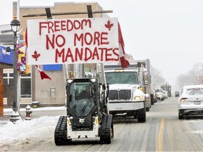A convoy of vehicles, unofficially estimated at about 200, rolled through Aylmer twice on Thursday. The protest was made up mainly of pickups and minivans, some adorned Canadian flags and with signs that read "No more mandates." (Mike Hensen/The London Free Press)