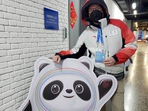 Sudbury Star columnist Randy Pascal poses for a photo with Bing Dwen Dwen, mascot for the 2022 Winter Olympics in Beijing. Pascal is working at the games as an off-ice hockey official.