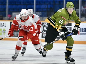 Kyle McDonald of the North Bay Battalion advances the puck as Tyler Savard of the visiting Sault Ste. Marie Greyhounds gives chase in Ontario Hockey League action Friday night. The Troops entertain the Kingston Frontenacs at 1 p.m. Sunday.
Tom Martineau Photo