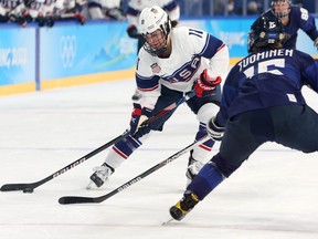 Abby Roque, of Team United States, takes on Minnamari Tuominen, of Team Finland, during the Women's Ice Hockey Preliminary Round Group action at Wukesong Sports Centre on Friday in Beijing, China. GETTY IMAGES