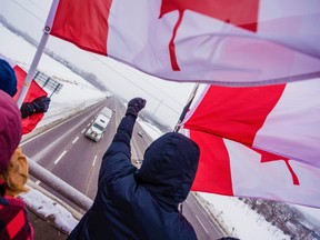 Freedom Convoy supporters lined overpasses on Highway 401 in Quinte as truck drivers made their way Ottawa to protest Jan. 22 vaccine mandates that all drivers must be vaccinated to cross the U.S.-Canada border. ALEX FILIPE