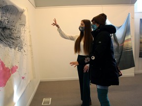 Artist Alix Voz discusses a piece of her work with Michelle Loubert of Sudbury, Saturday, at the Callander Bay Heritage Museum and Alex Dufresne Gallery.
PJ Wilson/The Nugget