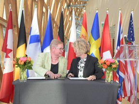 NWMO president and CEO Laurie Swami (right), signing a co-operation agreement with SKB in Toronto on May 14, 2018.SUBMITTED