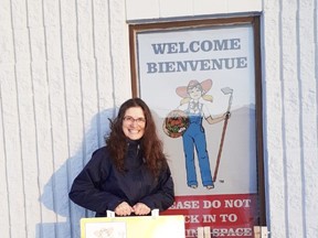 Tracy Simoneau, manager of the Peace River Farmers Market, encourages folks to watch for sandwich boards put up the day of the markets. The big arrows on brightly-coloured yellow sandwich boards direct people to the Industrial Hill Plaza. Photo submitted