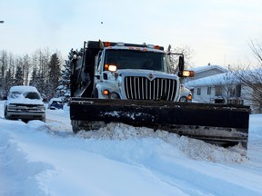 A snow plow gets to work in Fort McMurray on Thursday, Jan. 24, 2013. JORDAN THOMPSON/QMI Agency
