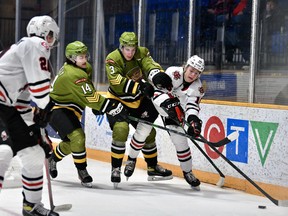 Dalyn Wakely and Cam Gauvreau of the host North Bay Battalion work against Ryan Struthers as Niagara IceDogs teammate Dylan Roobroeck arrives on the scene in Ontario Hockey League action Thursday night. The Battalion visits the Mississauga Steelheads on Friday night.
Tom Martineau Photo