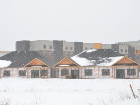 Townhomes under construction at Andpet Realty's Owen Sound Gardens development on Owen Sound's east side on Thursday, February 10, 2022. In the rear on the right is the development's retirement residence, while the white building on the left is the Southbridge Care Homes long-term care home development.