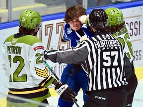 Kyle Jackson of the visiting North Bay Battalion lands a punch on Charlie Callaghan of the Mississauga Steelheads after Callaghan kneed Brandon Coe in Ontario Hockey League action Friday night. Matvey Petrov and linesman Jordan Hurtubise observe.

Sean Ryan Photo