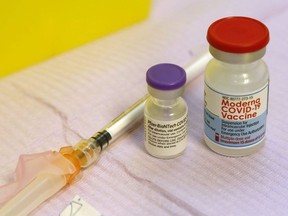 Vials of the Pfizer-BioNTech and Moderna COVID-19 vaccines sit with other vaccination supplies. File Photo
