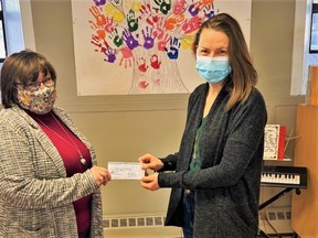Hastings and Prince Edward Business and Professional Women's Club president Jennifer May-Anderson presents a $500 cheque to Emily Pennington, executive director of Reaching for Rainbows.