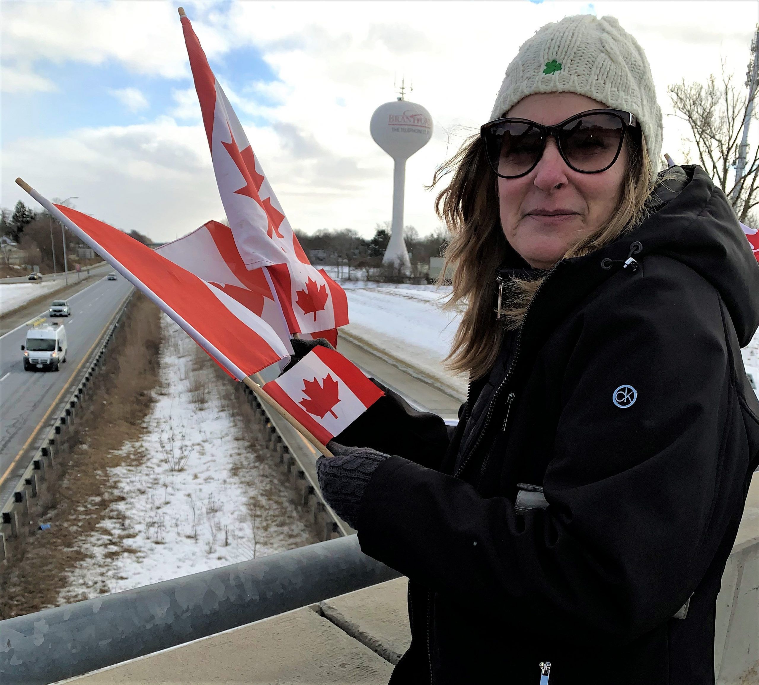 crowd-gathers-at-overpass-to-protest-against-covid-19-mandates-the