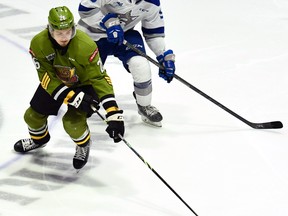 Kyle Jackson of the North Bay Battalion competes for the puck with Alex Assadourian of the visiting Sudbury Wolves on Sunday. It was Jackson's 100th Ontario Hockey League game.
Sean Ryan Photo