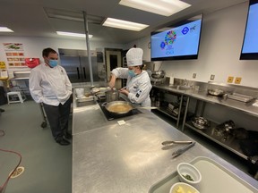 Canadore College Chef Fintan Flynn watches second-year Culinary Management student Mya Hilts as she competes in the IIHM International Young Chef Olympiad. Canadore took home the awards for Best Mentor for Chef Flynn and Hilts earned the award for Best Knife Skills.