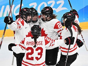 Canada's players celebrate their third goal during the women's playoffs semifinal match against Switzerland in the Beijing 2022 Winter Olympic Games on Feb. 14, 2022.  (file photo)