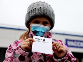 Five-year-old Piper Rhoden holds up her vaccine receipt after getting her second COVID-19 shot at the Brockville vacccination clinic on Thursday afternoon. (RONALD ZAJAC/The Recorder and Times)