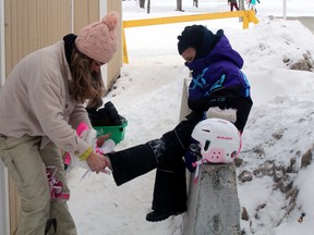 Jena Simpson helps Maylee Simpson with her skates, Monday, at the Lee Park skating oval. The skating oval and sliding hill at the park were popular places for Family Day activities.
PJ Wilson/The Nugget
