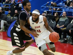 Dexter Williams Jr. (4) of the Sudbury Five drives around a Windsor Express player during NBLC action at Sudbury Community Arena on Monday afternoon.