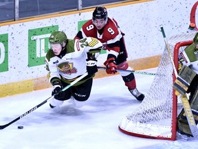 Chris Barlas of the Ottawa 67's, who received a crosschecking penalty, takes down Ty Nelson of the visiting North Bay Battalion as goaltender Dom DiVincentiis watches in Ontario Hockey League play Sunday. The Battalion continues on the road Thursday night against the Niagara IceDogs.
Sean Ryan Photo