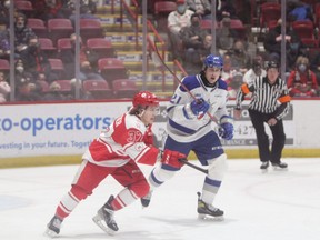 Soo Greyhounds forward Justin Cloutier and Sudbury Wolves forward Alex Pharand in first period action at the GFL Memorial Gardens on Wednesday night. Nolan Collins scored the game winner in overtime, the Wolves picking up a 6-5 win.