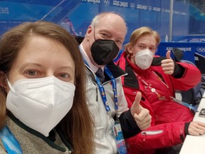 Sudbury Star columnist Randy Pascal, centre, in his element in the scorekeeper's both, alongside two of his fellow off-ice officials at the 2022 Beijing Olympics.