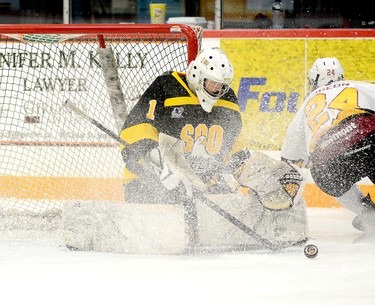 Soo Eagles goalie Gabe Rosek managed to keep the puck out of the net on this play despite being showered with snow by Timmins Rock forward Nicolas Pigeon during the first period of Friday night’s NOJHL contest at the McIntyre Arena. Rosek and the Eagles hung on to edge the Rock 3-2. The Rock will host the Hearst Lumberjacks at the McIntyre Arena on Sunday, at 3 p.m. THOMAS PERRY/THE DAILY PRESS