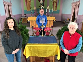 Canadians of Ukrainian descent in Norfolk County spoke out Thursday against Russia's invasion of their homeland.  Gathered at Sacred Heart Ukrainian Catholic Church in Waterford were, from left, Oksana Fito of Port Dover, Mike Mula of Waterford, and Mary Sitko, also of Waterford.  – Monte Sonnenberg