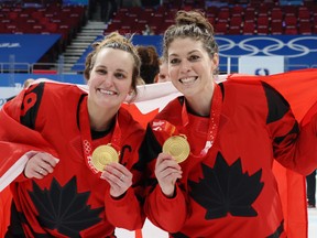 Gold medal winners Marie-Philip Poulin and Rebecca Johnston of Team Canada celebrate during the medal ceremony after the women's ice hockey gold-medal match between Team Canada and Team United States on Day 13 of the Beijing 2022 Winter Olympic Games at Wukesong Sports Centre on February 17, 2022 in Beijing, China.