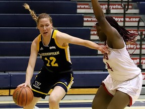 Sydney Tabin, of Laurentian Voyageurs, drives to the basket against Kiara Leveridge, of York Lions, during OUA basketball action at Laurentian University in Sudbury, Ont. on Thursday February 24, 2022. York defeated Laurentian 70-52.