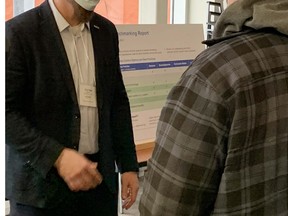 Algoma Steel environmental manager Fred Post chats with a member of the community about the modernization of the steelmaker and the positi8ve impact it will have on greenhouse emission reductions.  ELAINE DELLA-MATTIA.