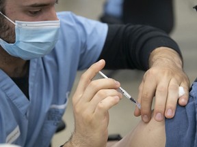 File: Patient receives a booster shot of COVID-19 vaccine