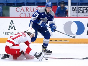 Ryan O'Rourke of the Soo Greyhounds tries to block a shot from Dominik Jendek of the Sudbury Wolves during OHL action at Sudbury Community Arena on Sunday, February 6, 2022.