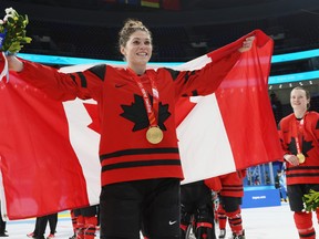 BEIJING, CHINA - FEBRUARY 17: Gold medal winner Rebecca Johnston #6 of Team Canada celebrates draped with a Canadian flag during the medal ceremony after the Women's Ice Hockey Gold Medal match between Team Canada and Team United States on Day 13 of the Beijing 2022 Winter Olympic Games at Wukesong Sports Centre on February 17, 2022 in Beijing, China.