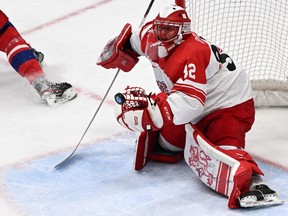 Denmark's goaltender Sebastian Dahm makes a save during the men's preliminary round group B match of the Beijing 2022 Winter Olympic Games ice hockey competition against Czech Republic, at the National Indoor Stadium in Beijing on February 9, 2022.
