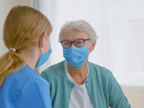 A Stonebridge Community Services life care worker (left) happily helps a client (right).