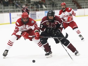 Chatham Maroons' Bryar Dittmer, right, battles Leamington Flyers' Colton O'Brien in the third period at Chatham Memorial Arena in Chatham, Ont., on Saturday, Feb. 12, 2022. Mark Malone/Chatham Daily News/Postmedia Network