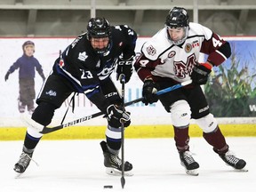 London Nationals' Sam Van der Zalm (23) and Chatham Maroons' Warren Clark (44) battle for the puck at Chatham Memorial Arena in Chatham, Ont., on Sunday, Feb. 20, 2022. Mark Malone/Chatham Daily News/Postmedia Network