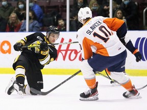 Sarnia Sting's Max Namestnikov chases down a shot while being defended by Flint Firebirds' Simon Slavicek in the first period at the Progressive Auto Sales Arena in Sarnia, Ont., Monday, Feb. 21, 2022. Mark Malone/Chatham Daily News/Postmedia Network
