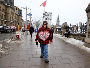 A demonstrator with the Freedom Convoy is pictured on Wellington Street in Ottawa on Feb. 10, 2022.