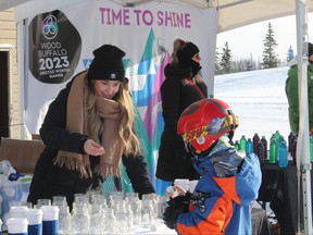 A volunteer at a pop-up winter carnival promoting the 2023 Wood Buffalo Arctic Winter Games. Jenna Hamilton/Fort McMurray Today/Postmedia Network