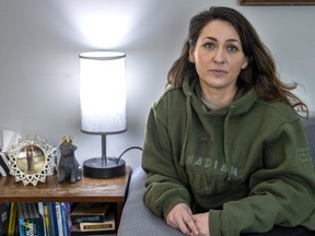 Brandy Robertson, 39, seen here wearing her late father, Neil Reece's Canadian Army hoodie, has seen COVID-19's impact on London hospitals first-hand: the pandemic delayed Reece's surgery three times last year. Sadly, weakened by a five-year wait for a transplant, he died 113 days after the procedure. (Mike Hensen/The London Free Press)